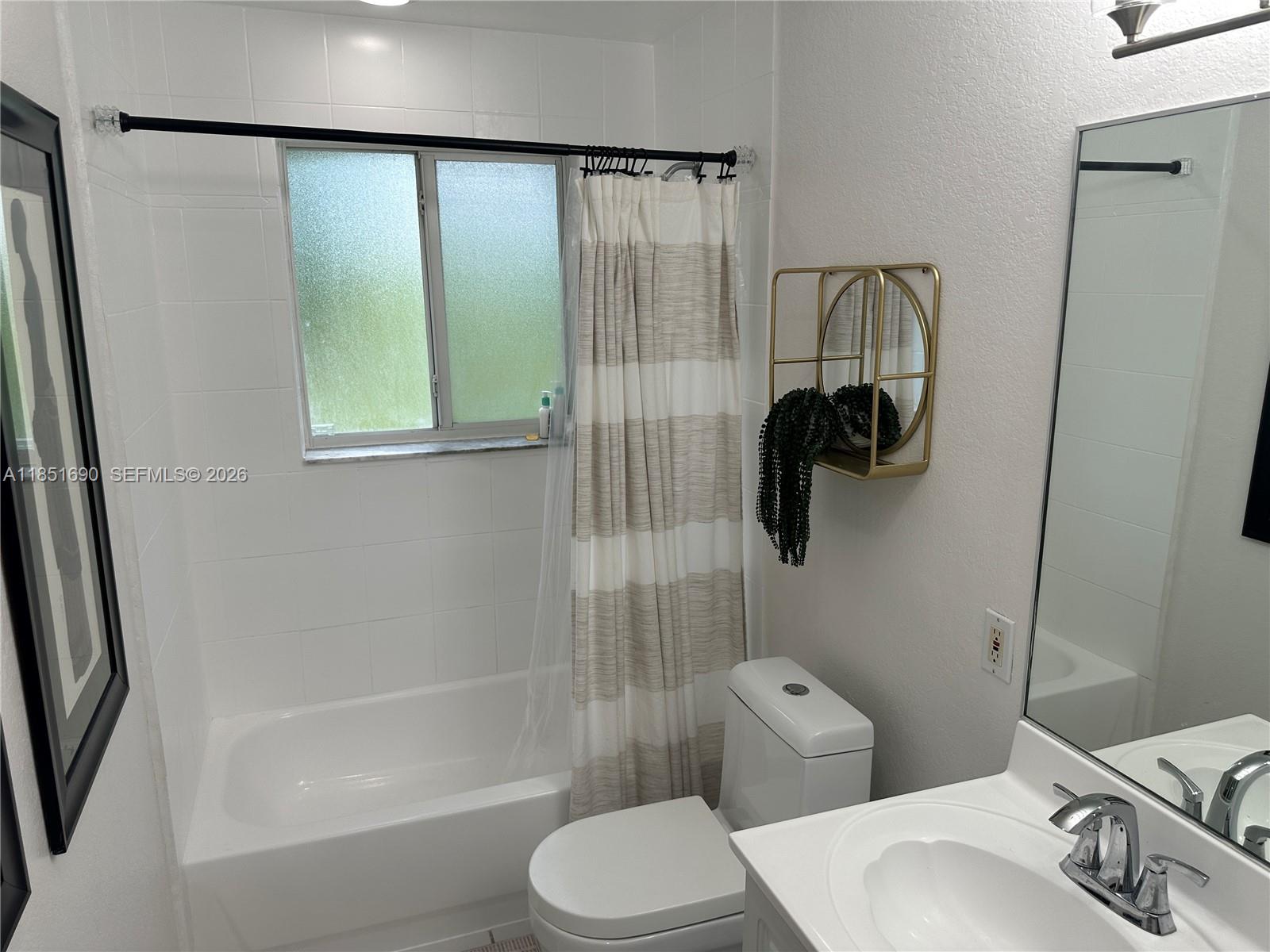 11 Northeast 151st Street Miami, FL 33162 - Photo 55 of 95 a bathroom with a sink a toilet and shower