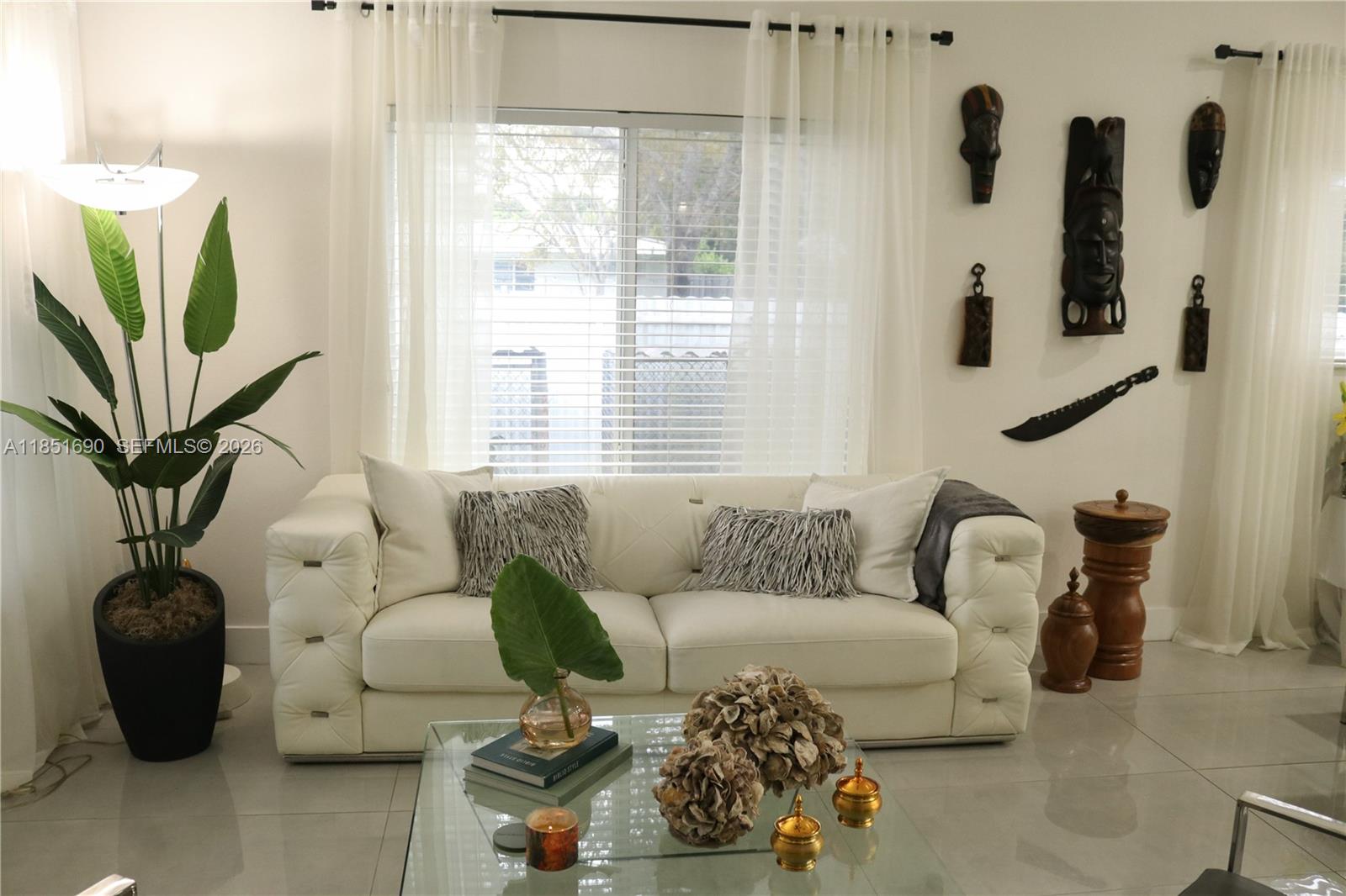 11 Northeast 151st Street Miami, FL 33162 - Photo 6 of 95 a living room with furniture and a potted plant