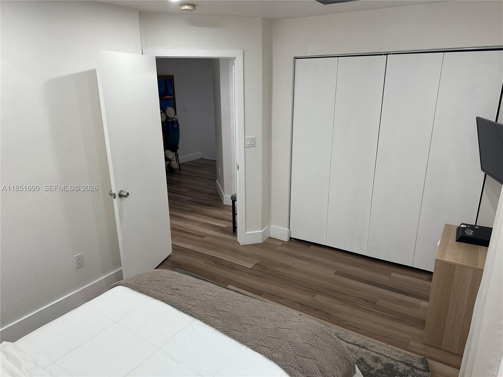 11 Northeast 151st Street Miami, FL 33162 - Photo 71 of 95 a view of a hallway with wooden floor and closet