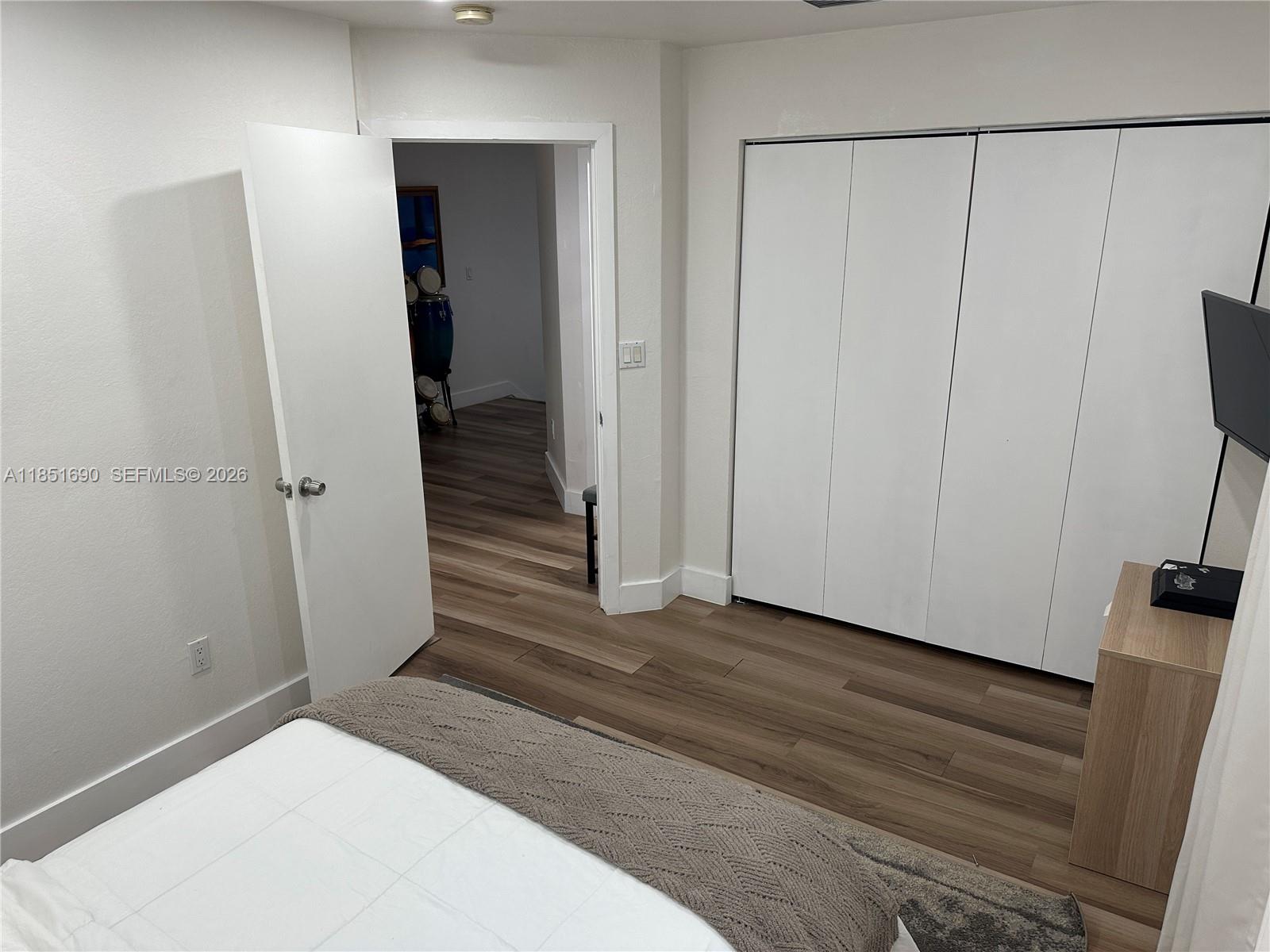 11 Northeast 151st Street Miami, FL 33162 - Photo 72 of 95 a view of a hallway with wooden floor and closet