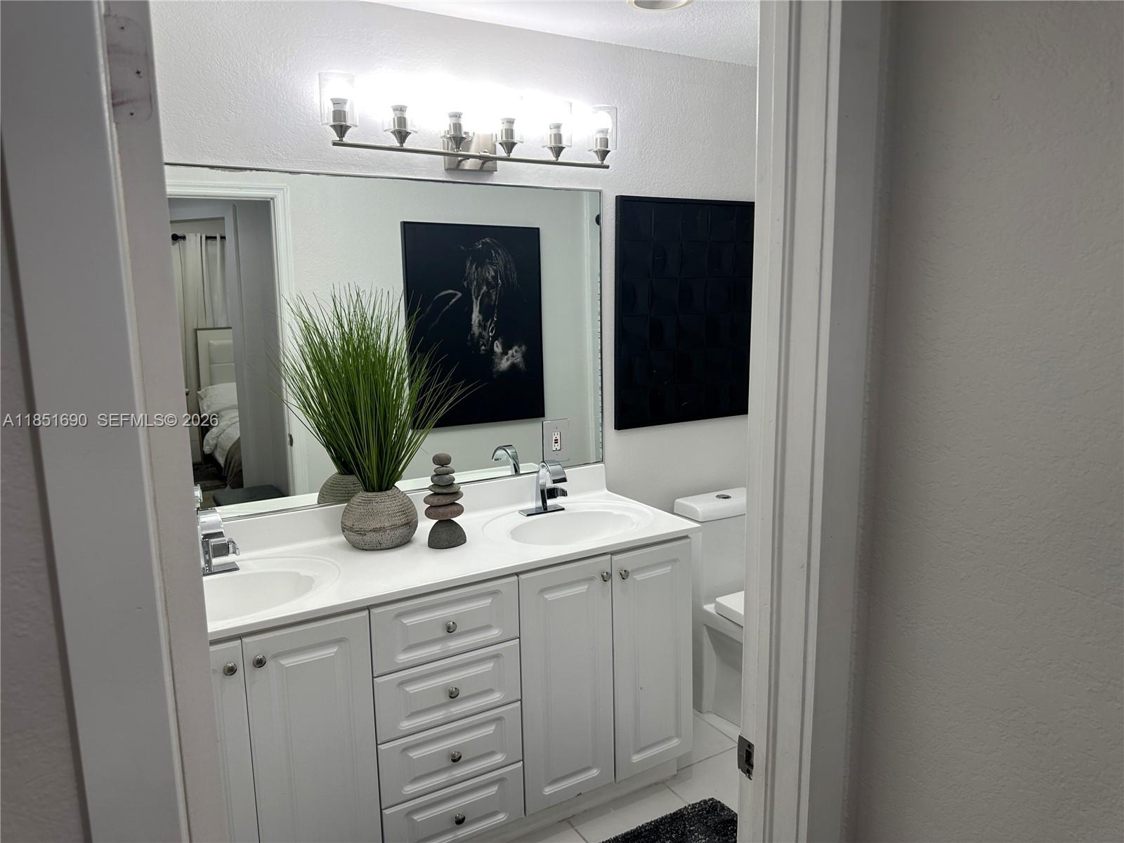 11 Northeast 151st Street Miami, FL 33162 - Photo 78 of 95 a bathroom with a sink and a mirror
