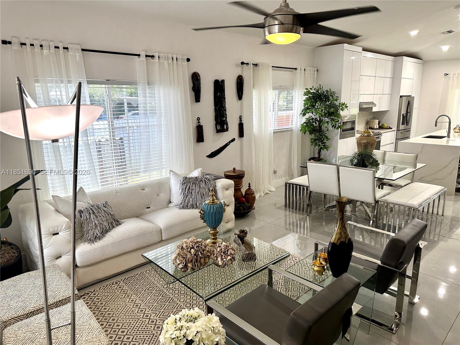 11 Northeast 151st Street Miami, FL 33162 - Photo 8 of 95 a living room with furniture and a large window