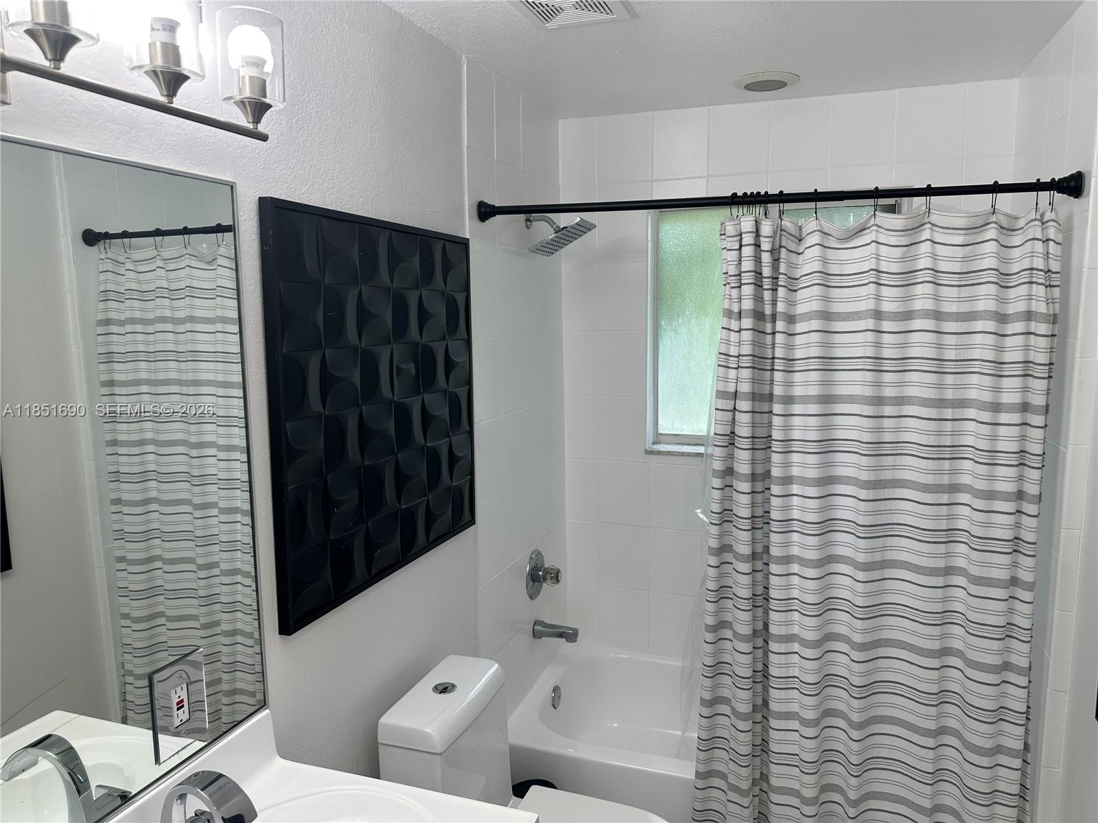 11 Northeast 151st Street Miami, FL 33162 - Photo 84 of 95 a bathroom with a shower and a toilet
