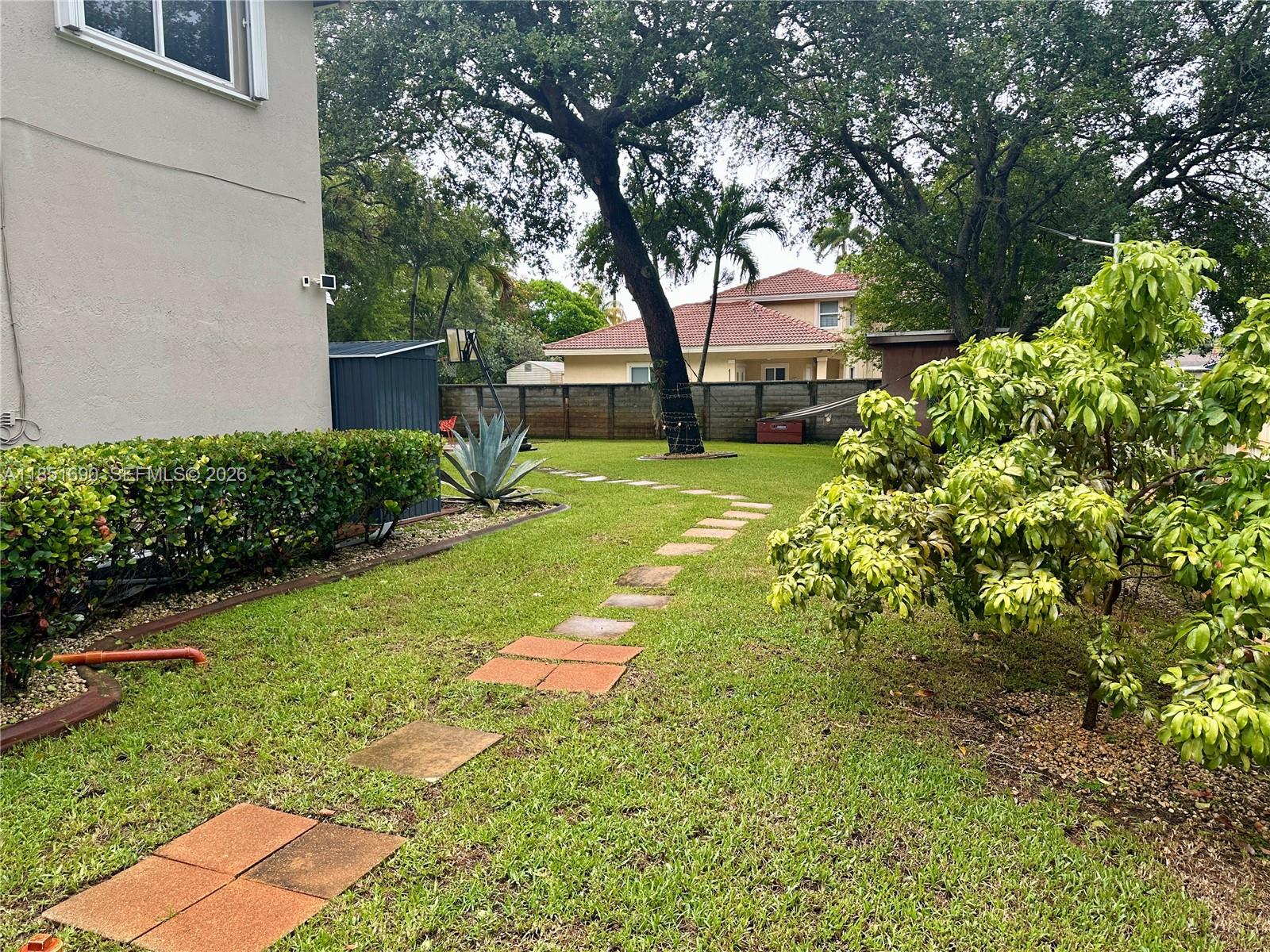 11 Northeast 151st Street Miami, FL 33162 - Photo 90 of 95 a front view of a house with garden