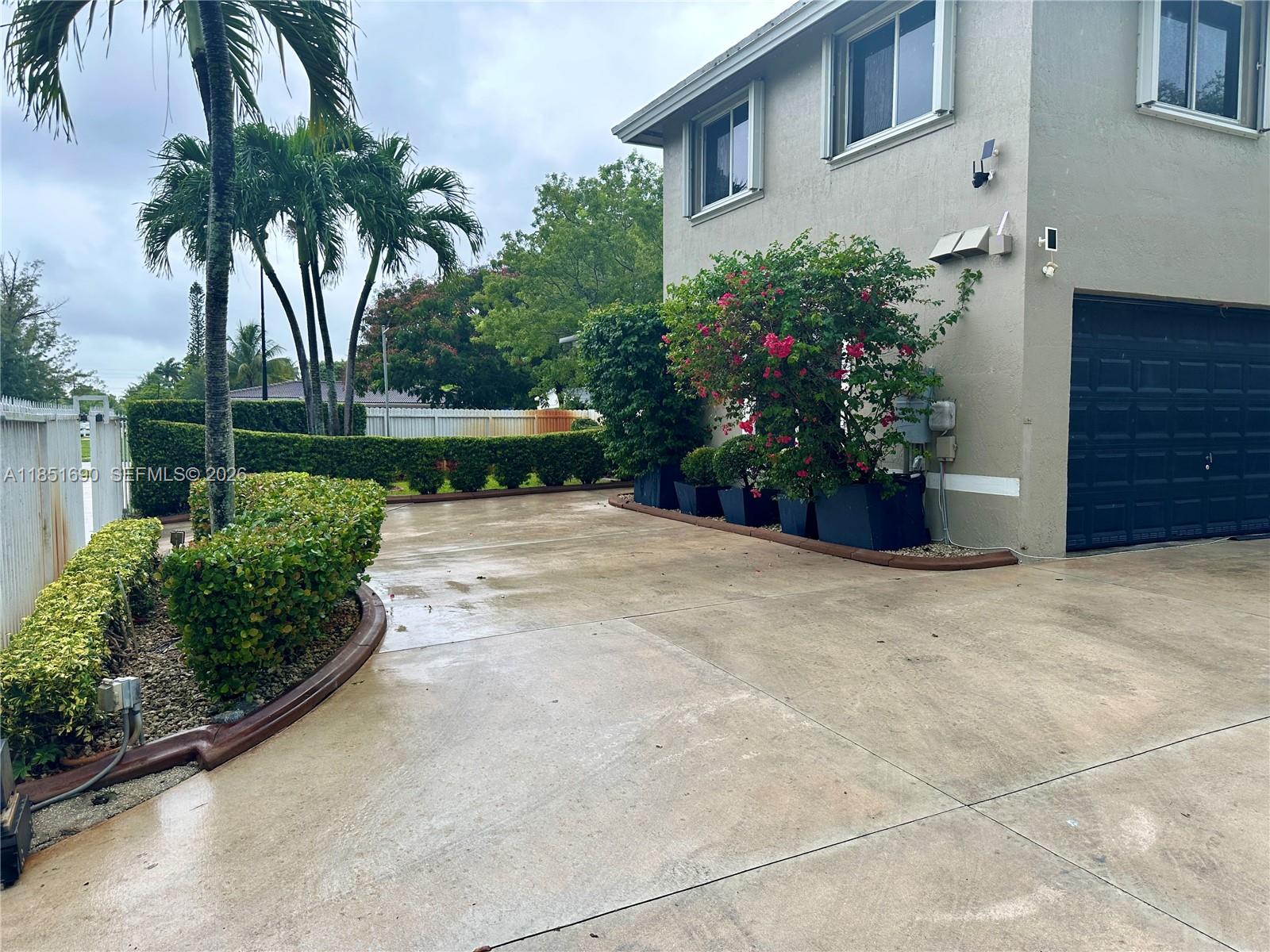 11 Northeast 151st Street Miami, FL 33162 - Photo 93 of 95 a view of a house with a yard and potted plants