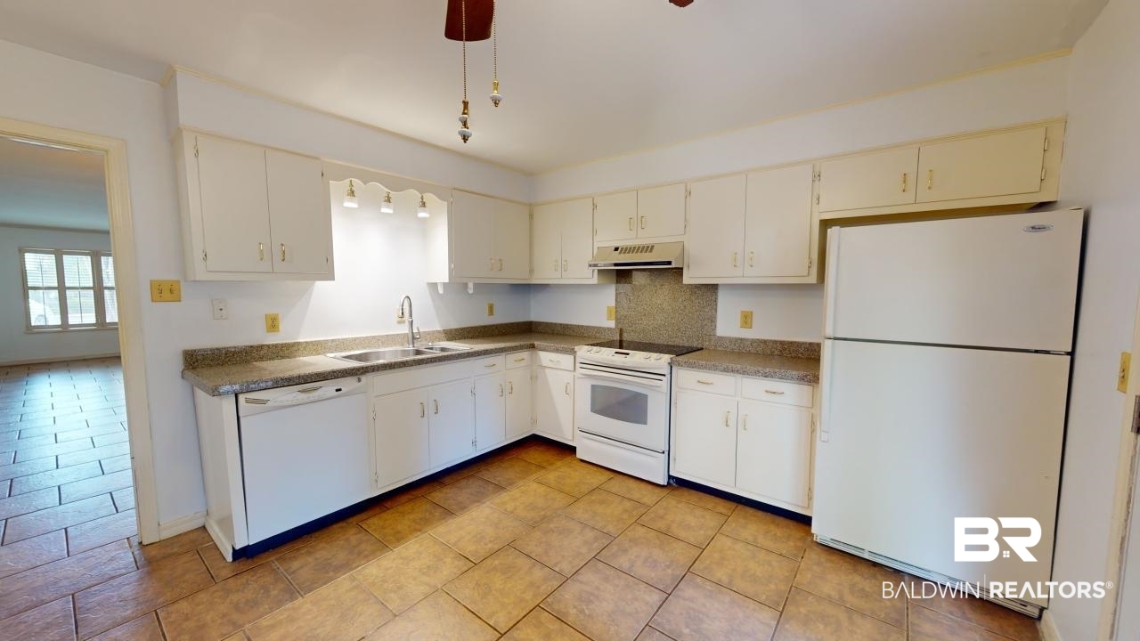 4009 Old Shell Road, Unit C13 Mobile, AL 36608 - Photo 10 of 32 Kitchen with white appliances, a sink, exhaust hood, and dark countertops