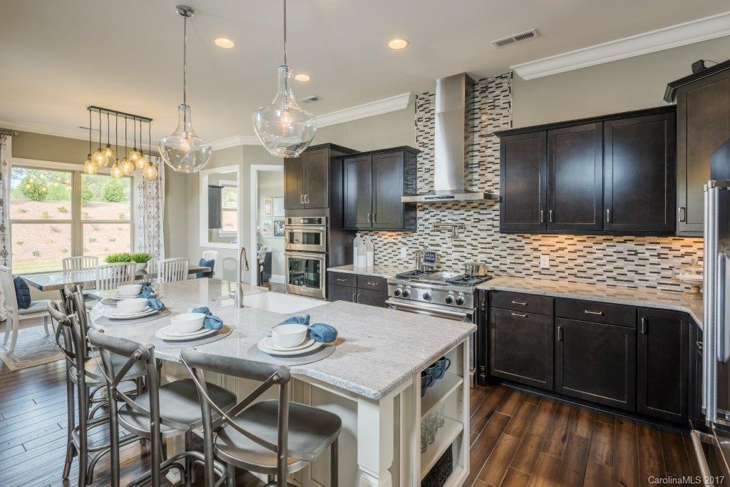 6026 Fallondale Road, Unit MB520 Waxhaw, NC 28173 - Photo 1 of 1 a kitchen with stainless steel appliances kitchen island granite countertop a stove refrigerator and cabinets