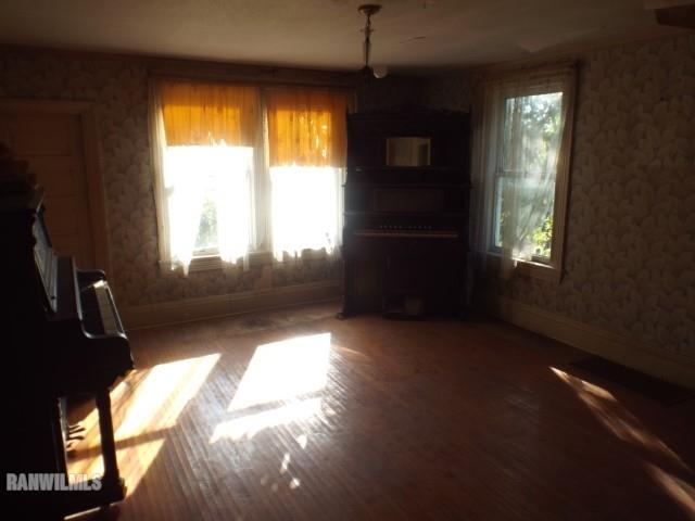10905 South Massbach Road Elizabeth, IL 61028 - Photo 4 of 41 a view of an empty room with wooden floor and a window