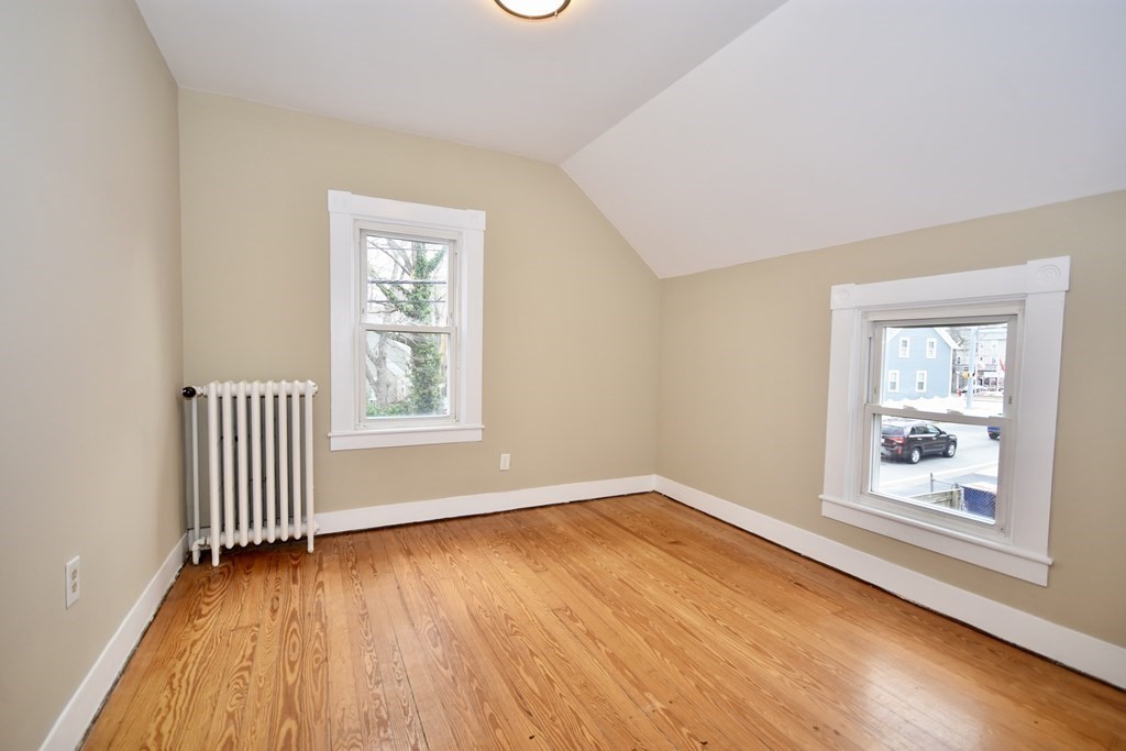 253 Adams Street Fairhaven, MA 02719 - Photo 11 of 17 a view of an empty room with wooden floor and a window