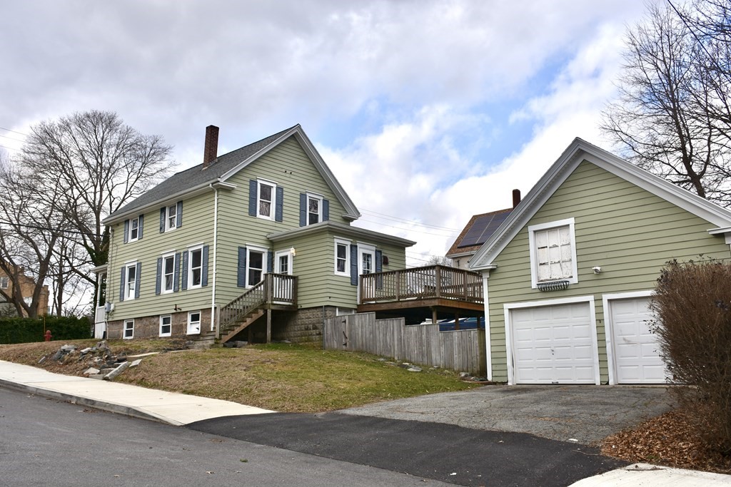 253 Adams Street Fairhaven, MA 02719 - Photo 3 of 17 a front view of a house with a yard and garage