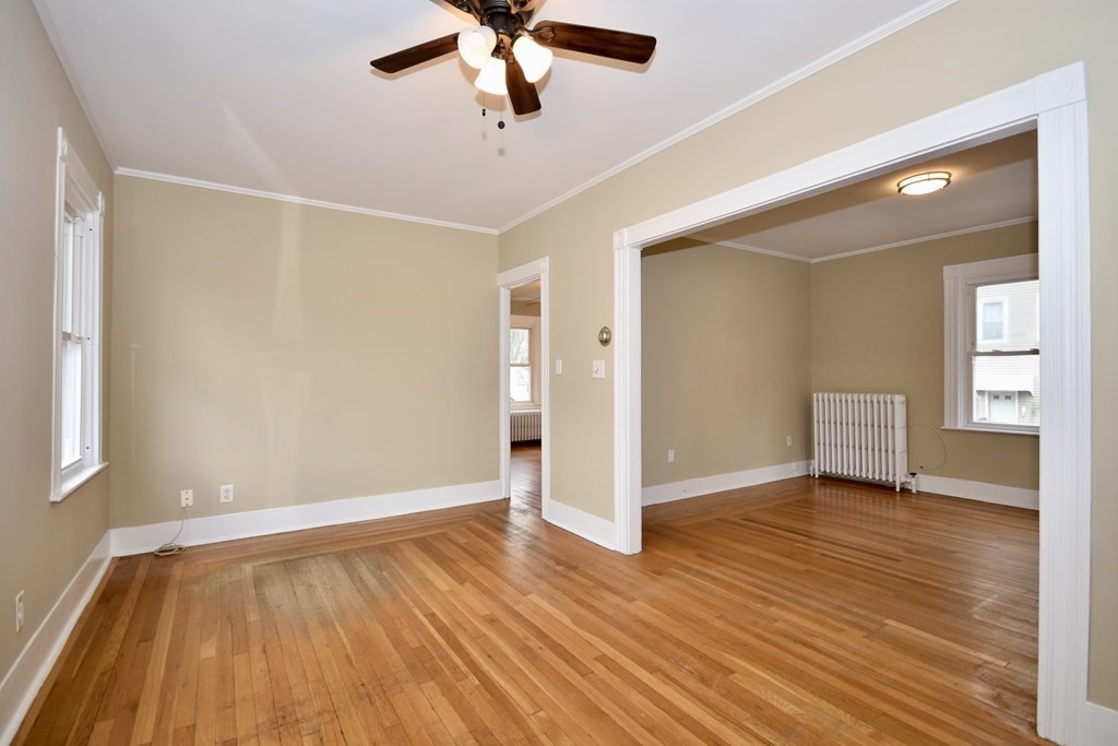 253 Adams Street Fairhaven, MA 02719 - Photo 6 of 17 wooden floor in an empty room with a window