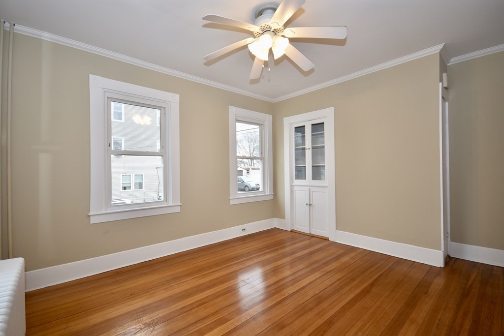 253 Adams Street Fairhaven, MA 02719 - Photo 7 of 17 a view of an empty room with wooden floor and a window