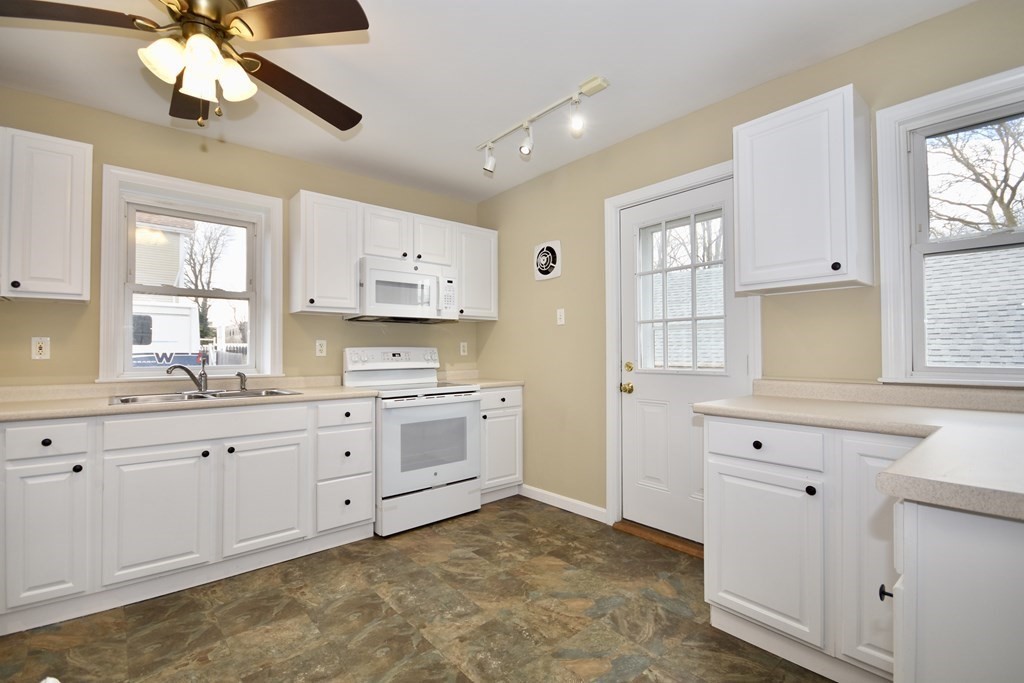 253 Adams Street Fairhaven, MA 02719 - Photo 8 of 17 a large white kitchen with cabinets