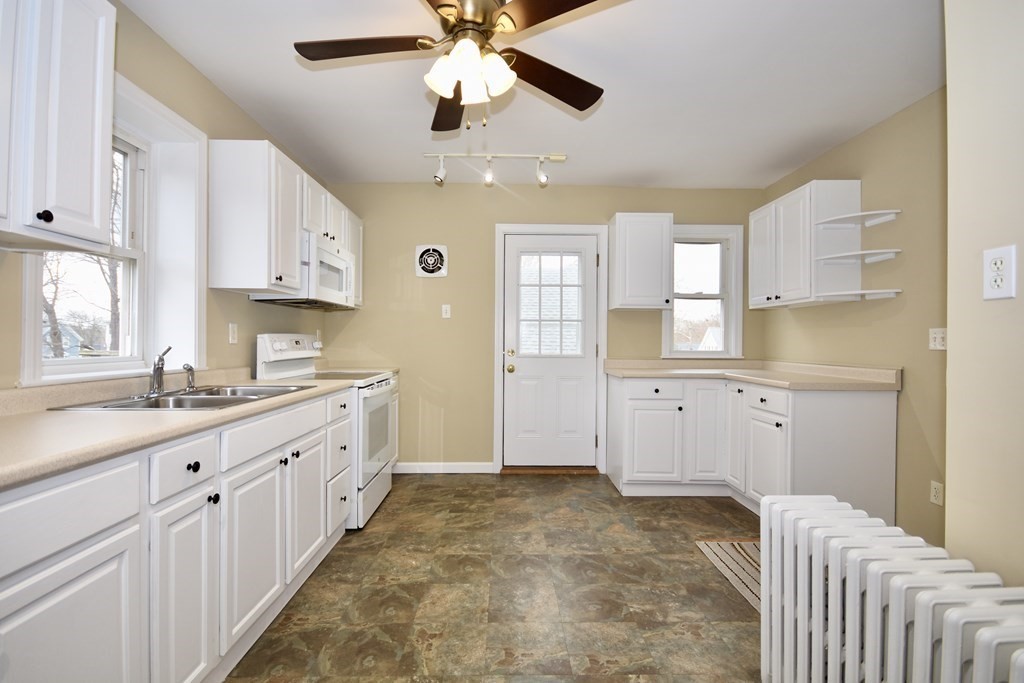 253 Adams Street Fairhaven, MA 02719 - Photo 9 of 17 a kitchen with cabinets and window