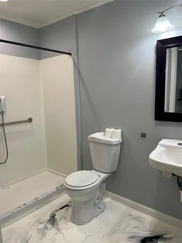 a bathroom with a toilet and a shower