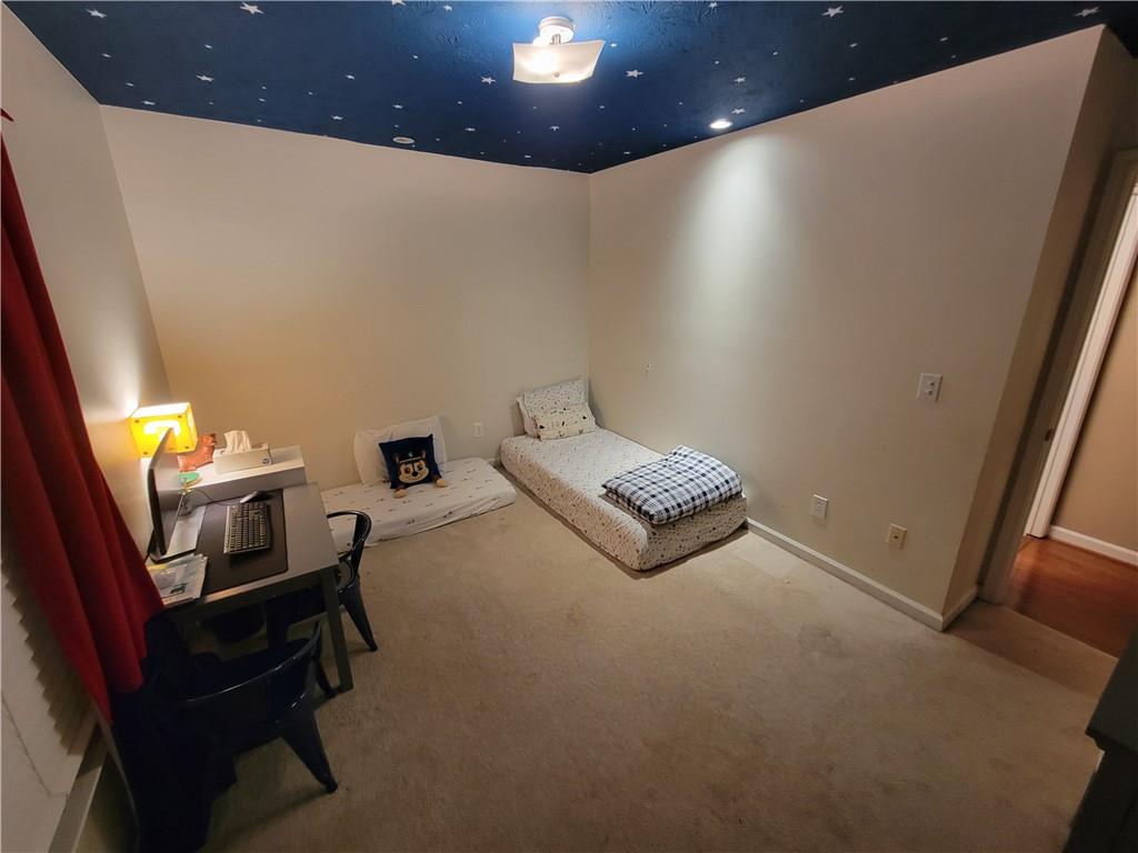 1002 Cedar Trace Southwest Lilburn, GA 30047 - Photo 11 of 11 a living room with furniture and a piano