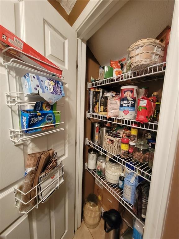 1002 Cedar Trace Southwest Lilburn, GA 30047 - Photo 6 of 11 a store room with lots of different colored cloths