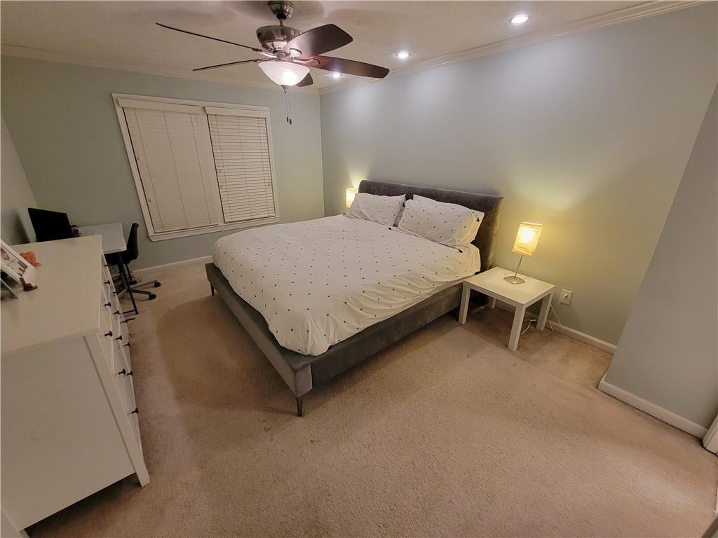 1002 Cedar Trace Southwest Lilburn, GA 30047 - Photo 7 of 11 a bedroom with a bed and a chandelier