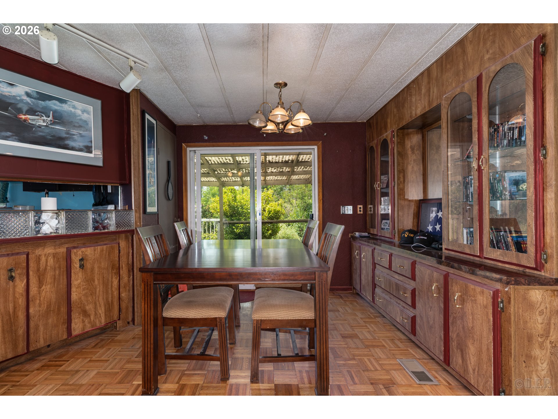 66971 Maplecrest Road Deer Island, OR 97054 - Photo 9 of 24 a dining room with wooden floor a chandelier a wooden table and chairs