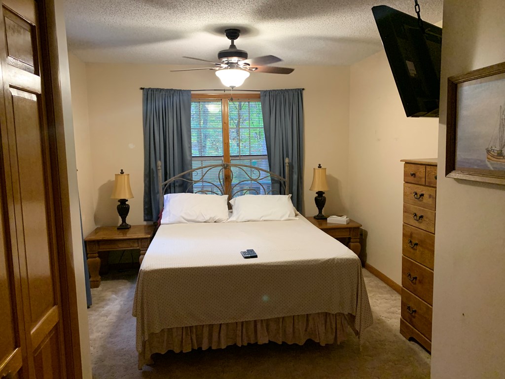 55 Laurel Spring Drive Murphy, NC 28906 - Photo 30 of 73 a spacious bedroom with a bed and a chandelier