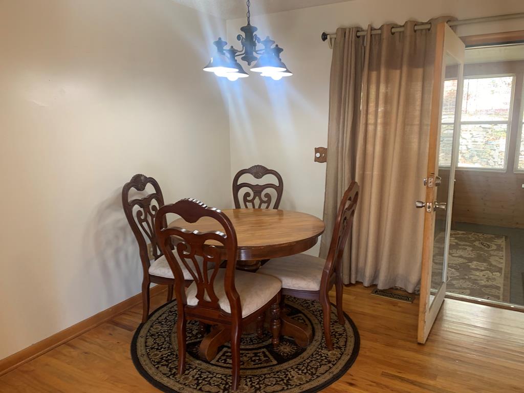 55 Laurel Spring Drive Murphy, NC 28906 - Photo 73 of 73 a dining room with furniture a chandelier and wooden floor