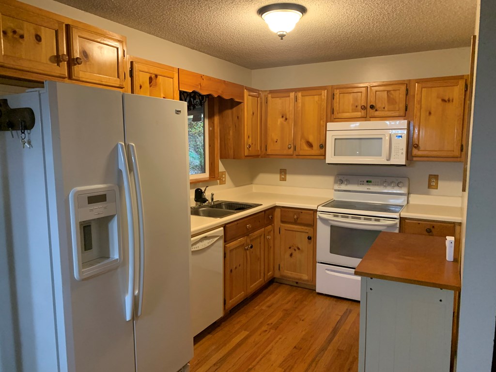 55 Laurel Spring Drive Murphy, NC 28906 - Photo 10 of 73 a kitchen with a refrigerator sink and stove top oven