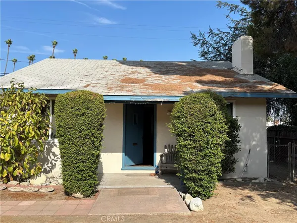 a view of a house with potted plants