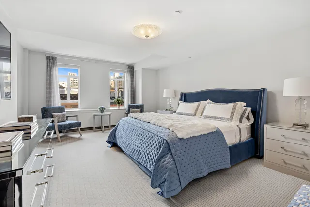 a spacious bedroom with a bed and a large window