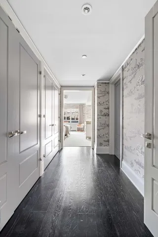 a view of a big room with wooden floor and windows