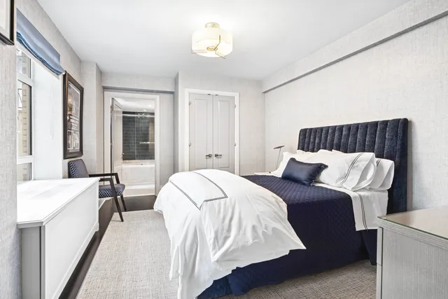 a bed room with a bed and a chair