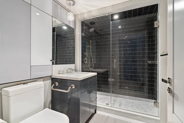 a bathroom with a sink toilet and shower