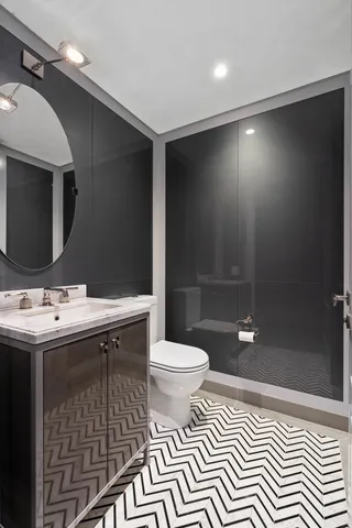 a bathroom with a sink a toilet and shower