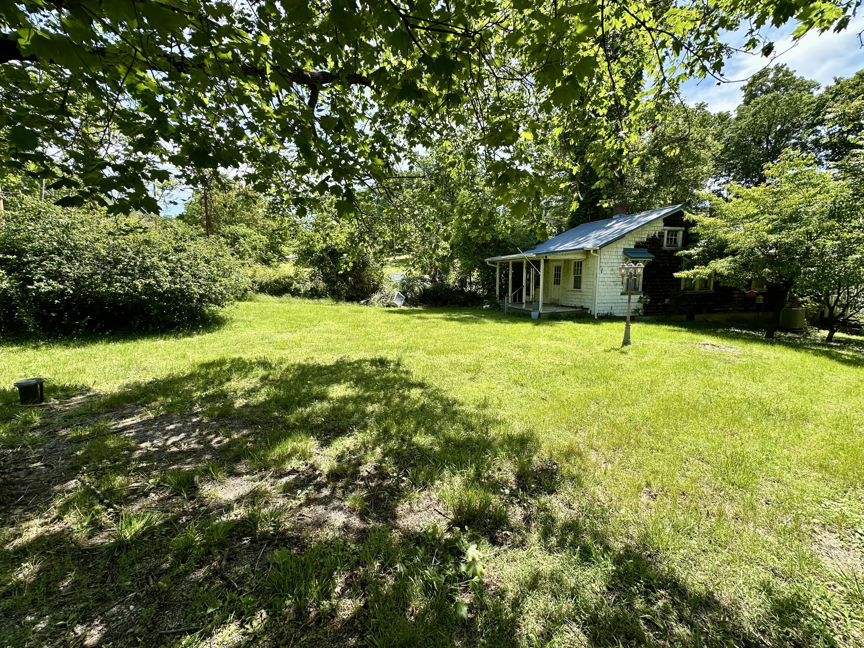 1074 Lynn Lane Blue Ridge, VA 24064 - Photo 5 of 6 a backyard of a house with yard and outdoor seating