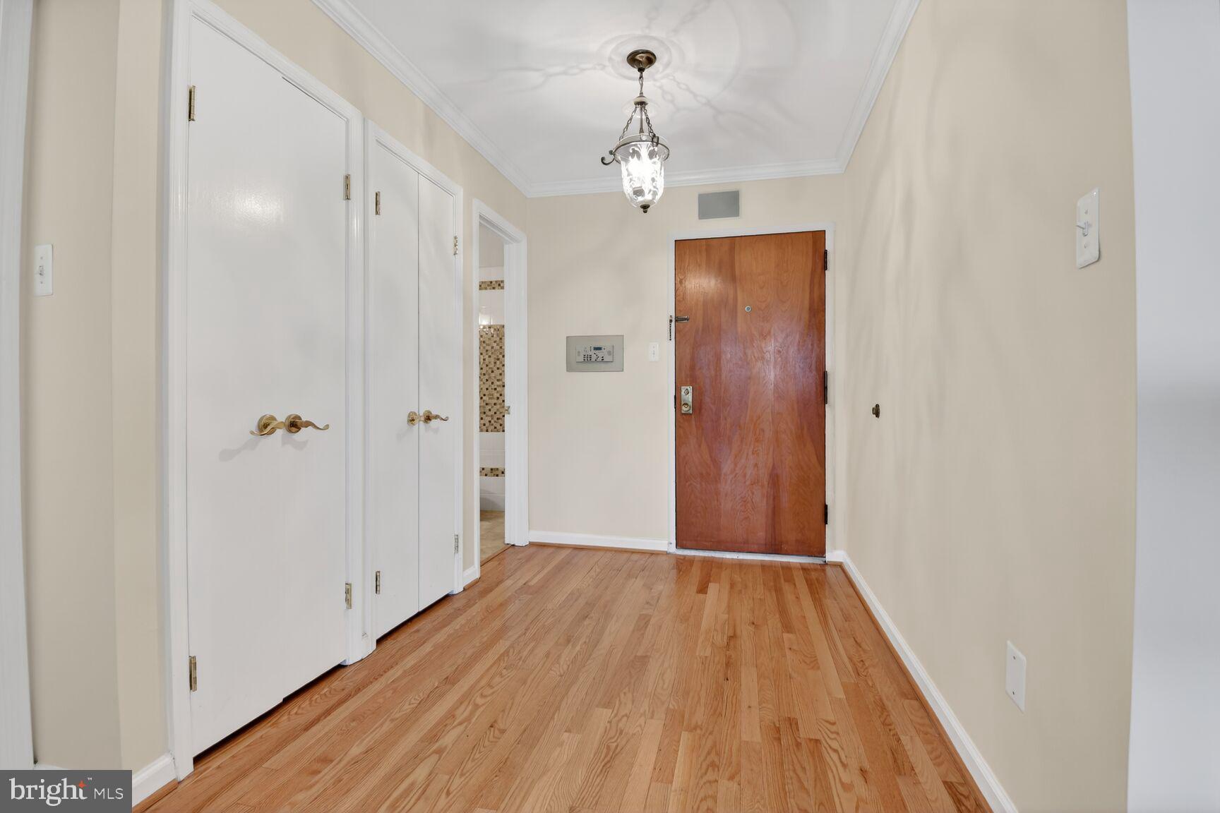 1101 South Arlington Ridge Road, Unit 504 Arlington, VA 22202 - Photo 13 of 37 a view of a hallway with wooden floor and closet