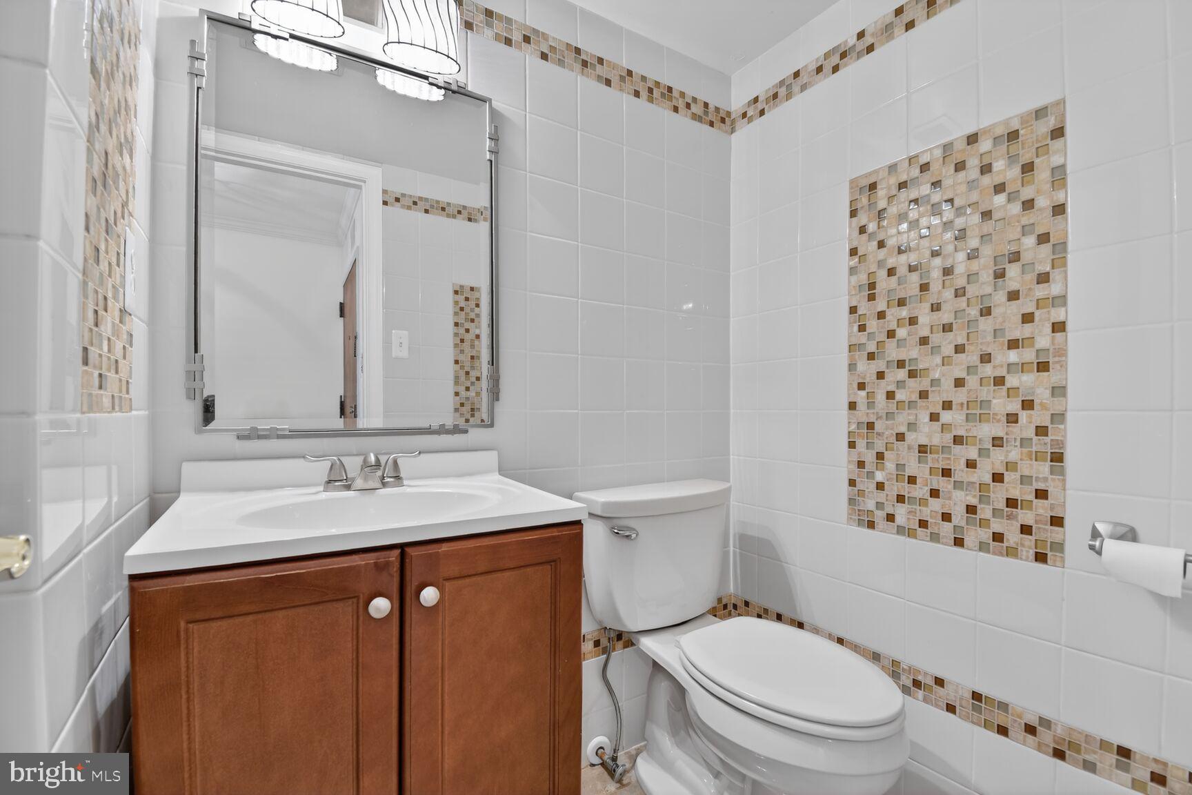 1101 South Arlington Ridge Road, Unit 504 Arlington, VA 22202 - Photo 14 of 37 a bathroom with a sink toilet vanity and shower