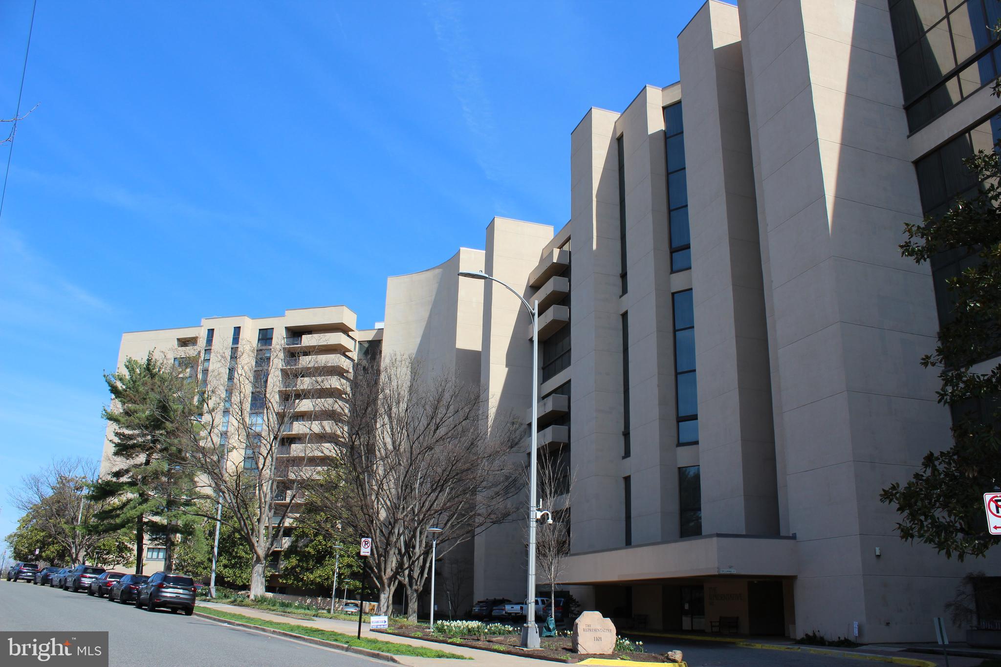 1101 South Arlington Ridge Road, Unit 504 Arlington, VA 22202 - Photo 2 of 37 a view of a building with glass windows and a yard