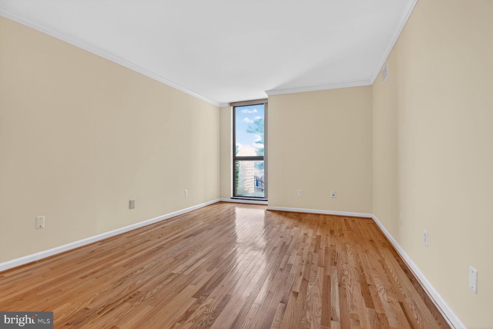 1101 South Arlington Ridge Road, Unit 504 Arlington, VA 22202 - Photo 21 of 37 a view of an empty room with wooden floor and window