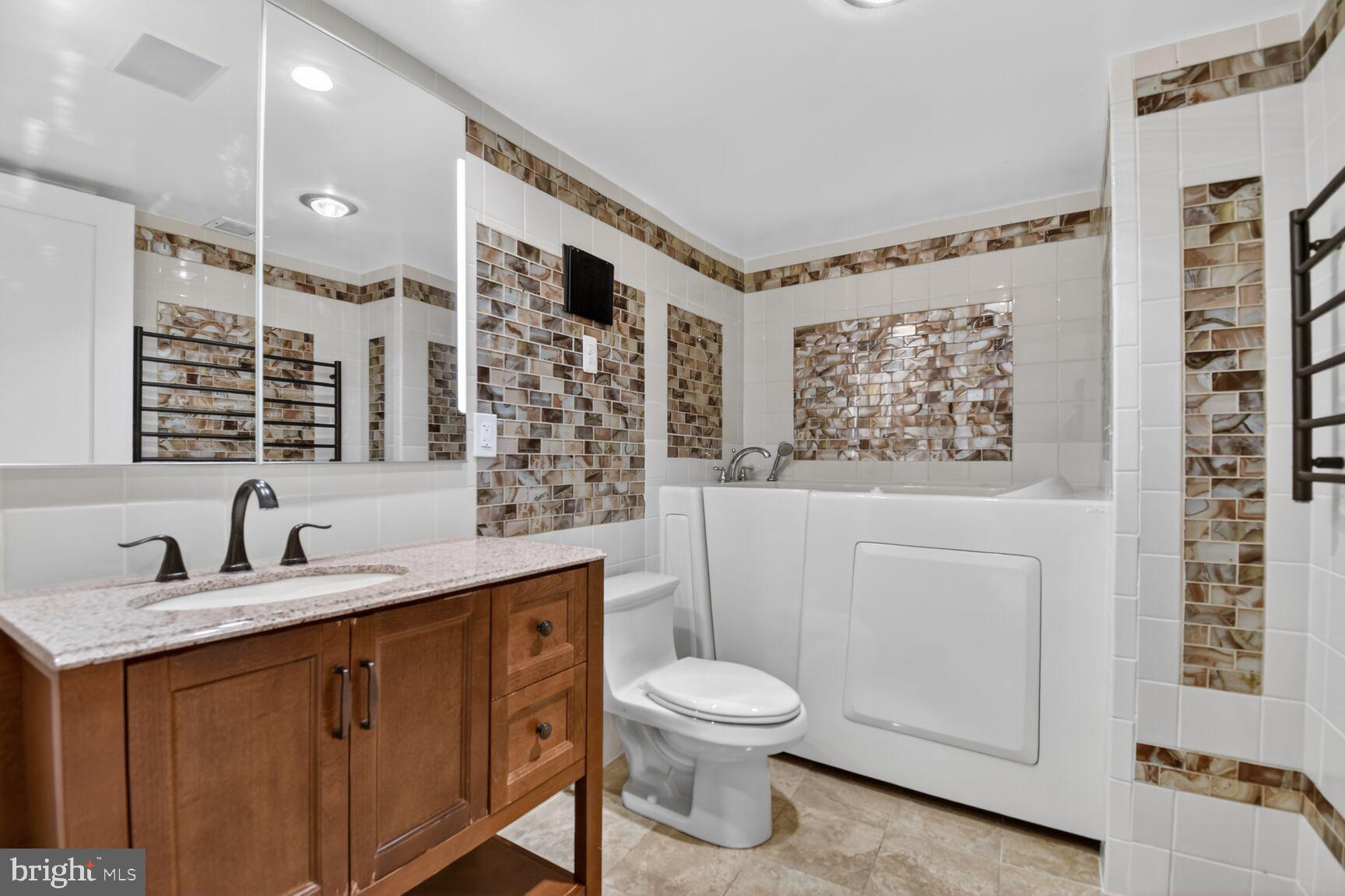 1101 South Arlington Ridge Road, Unit 504 Arlington, VA 22202 - Photo 23 of 37 a bathroom with a toilet sink and mirror