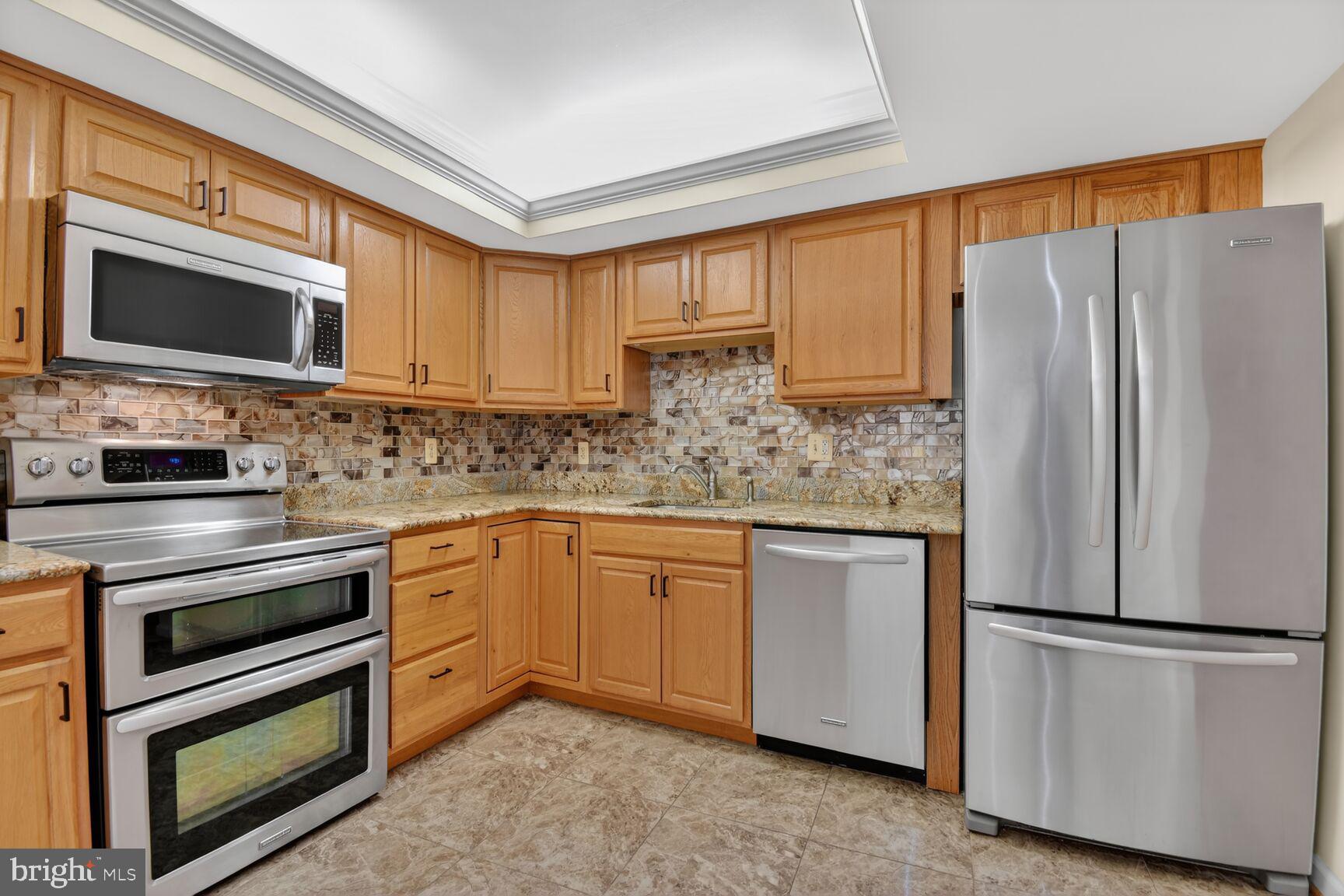 1101 South Arlington Ridge Road, Unit 504 Arlington, VA 22202 - Photo 5 of 37 a kitchen with stainless steel appliances a refrigerator sink and microwave