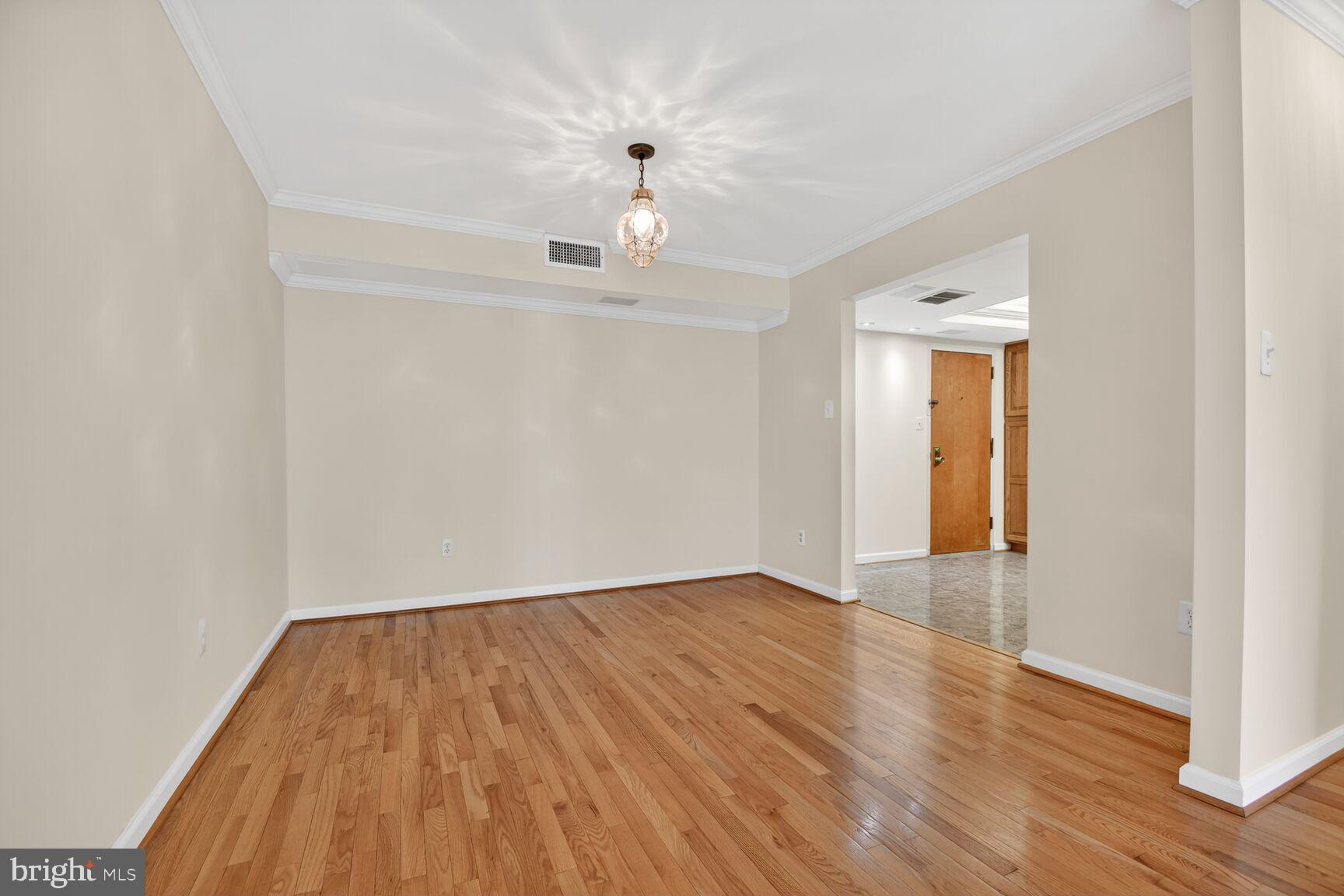 1101 South Arlington Ridge Road, Unit 504 Arlington, VA 22202 - Photo 8 of 37 wooden floor in an empty room with a window