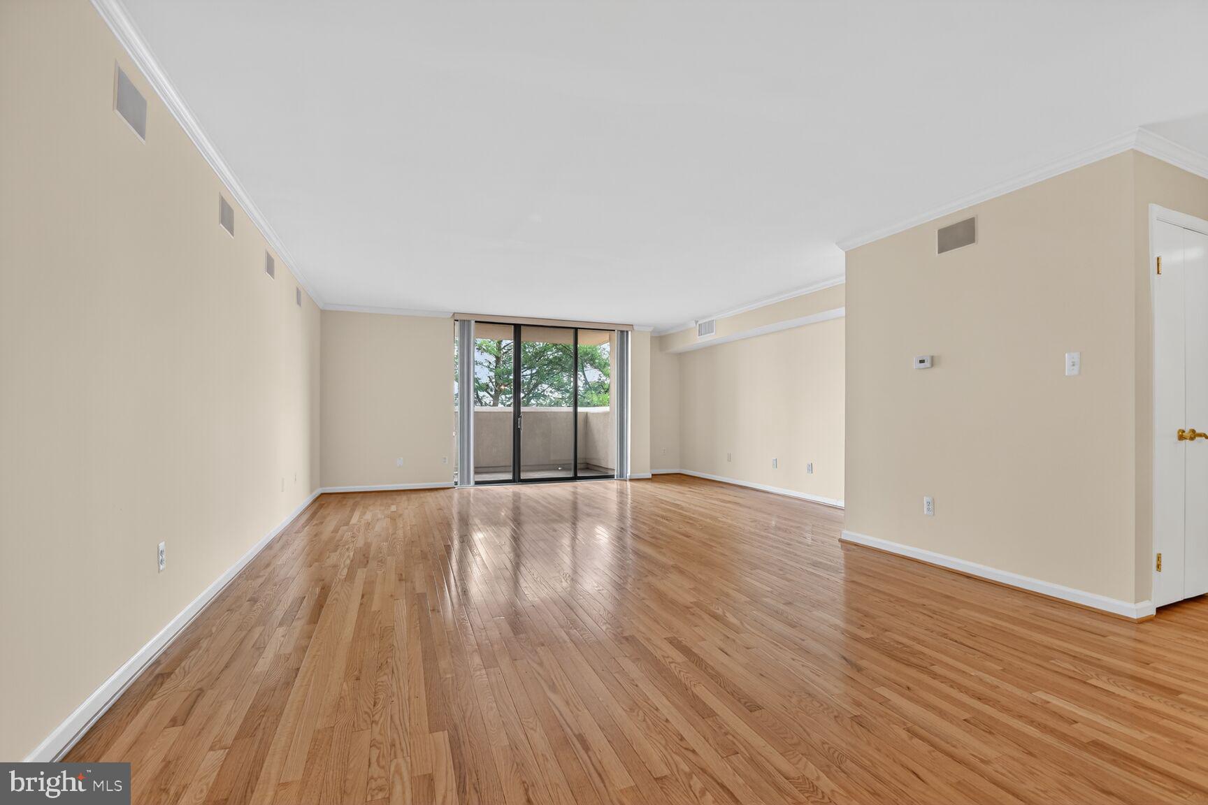 1101 South Arlington Ridge Road, Unit 504 Arlington, VA 22202 - Photo 10 of 37 an empty room with wooden floor and windows
