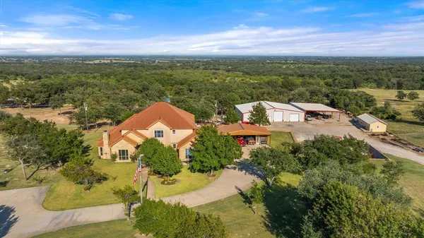 an aerial view of a house with a lake view