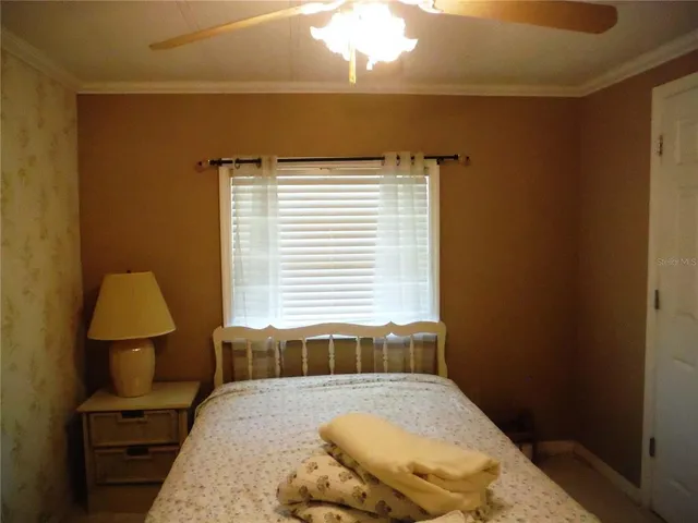 a bedroom with a bed and a lamp