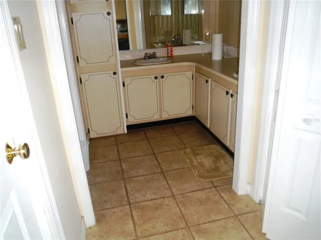 a kitchen with a sink and cabinets