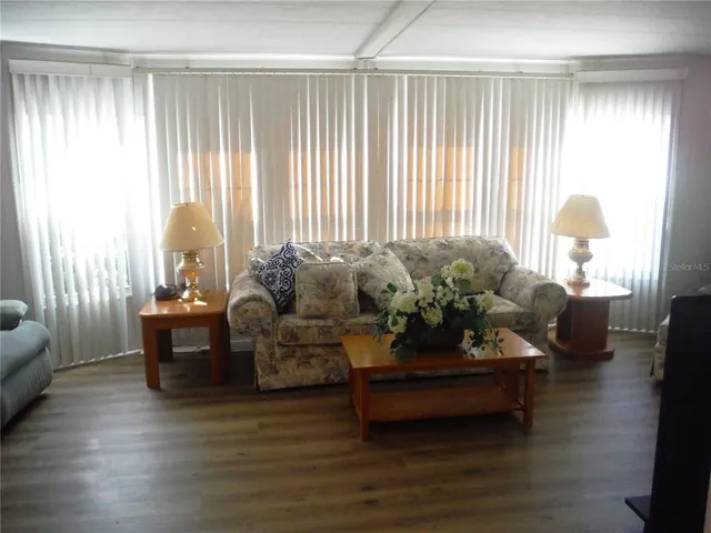 a living room with furniture and a large window