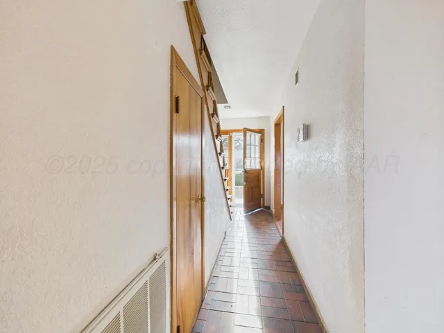 a view of workspace with window and wooden floor