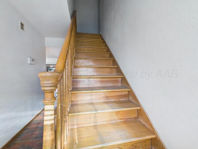 a view of hallway with wooden floor