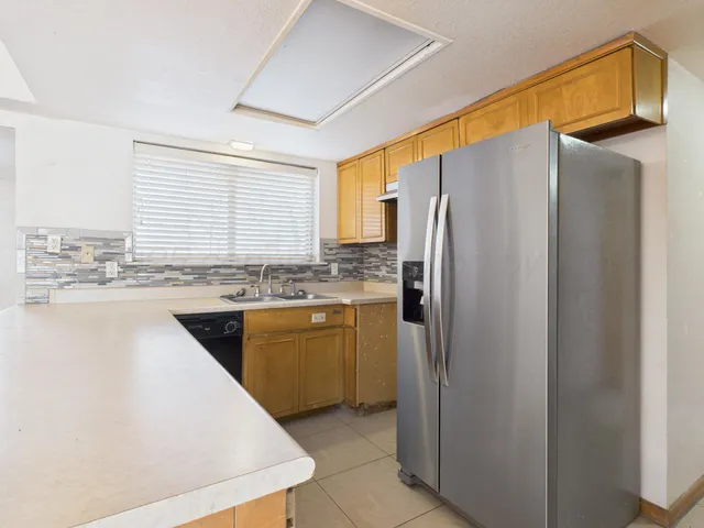 a kitchen with stainless steel appliances a refrigerator sink and cabinets