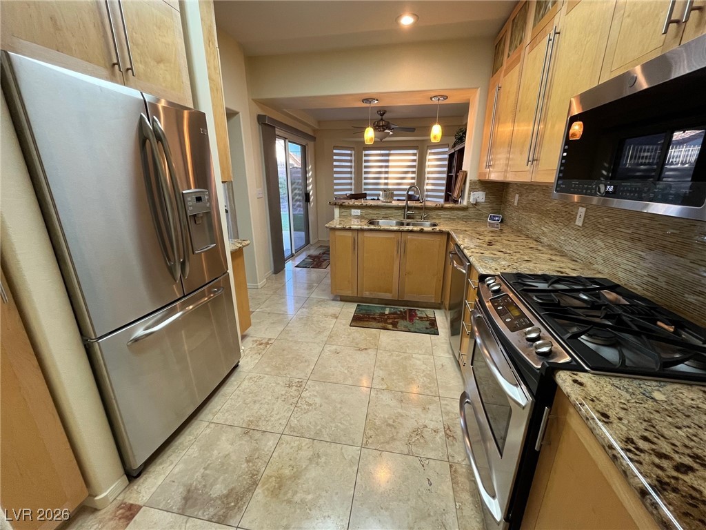 11021 Rackhurst Avenue Las Vegas, NV 89134 - Photo 4 of 53 gorgeous kitchen with custom cabinets, stainless appliances