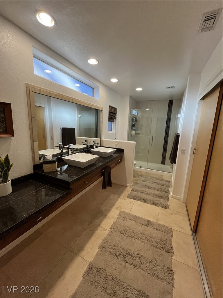11021 Rackhurst Avenue Las Vegas, NV 89134 - Photo 7 of 53 Custom Cabinets in closet, nice granite and tiled shower. Walk-in Closet to right